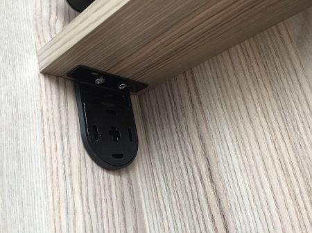 Bracket held against the wall recess ready to mark drill points